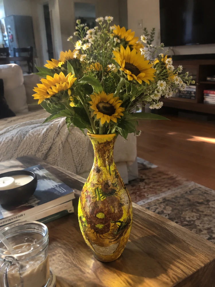 Sunflowers in a puzzle vase in a sunlit living room